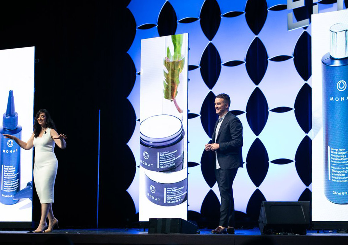 Two MONAT staff members on the MONATions stage presenting the launch of the Damage Repair Line.