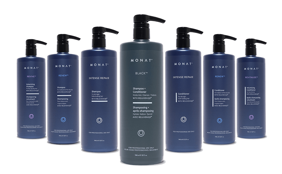 Row of MONAT hair care products saloon size including shampoos, conditioners in dark blue and purple bottles arranged in a line