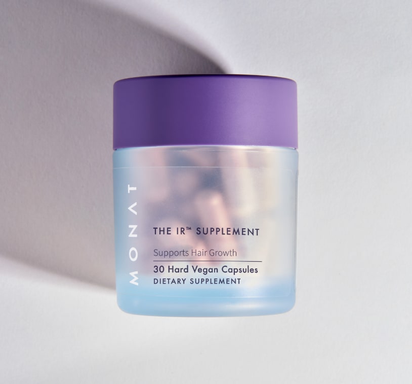 The MONAT supplement bottle photographed at an angle against a light background with soft shadowing