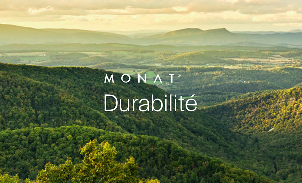 The MONAT Sustainability logo overlaying a photo of greenery and mountains.