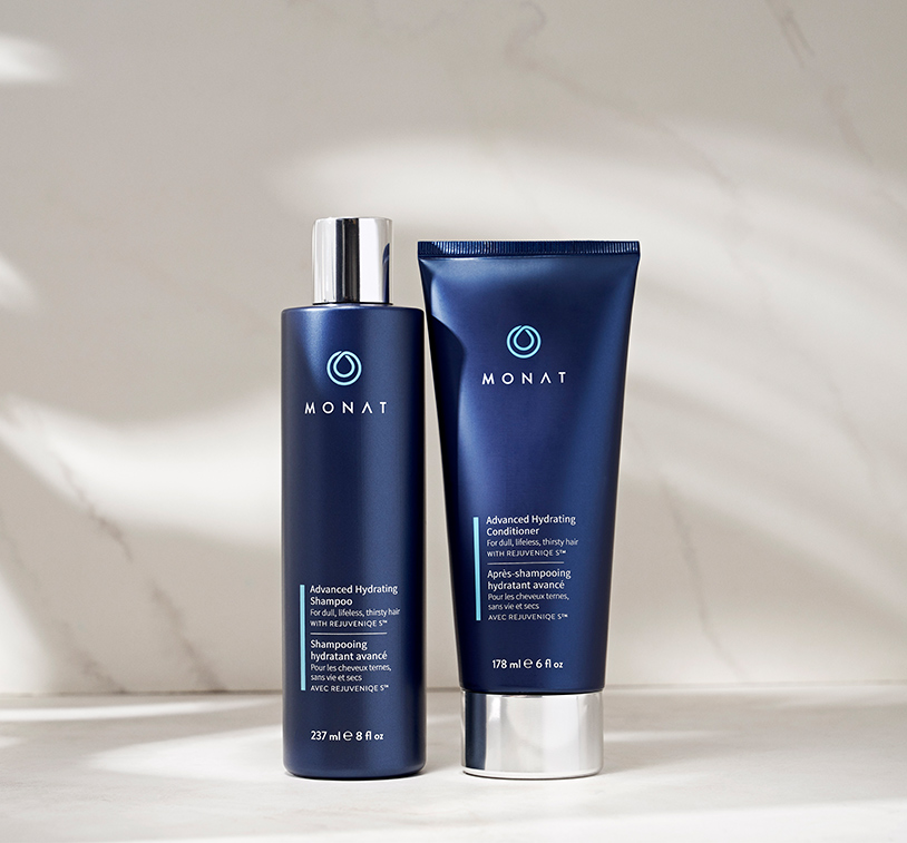 Advanced Hydrating Shampoo and Advanced Hydrating Conditioner on a marble surface.
