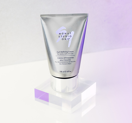 MONAT STUDIO ONE™ Curl Defining Cream on a clear cube.