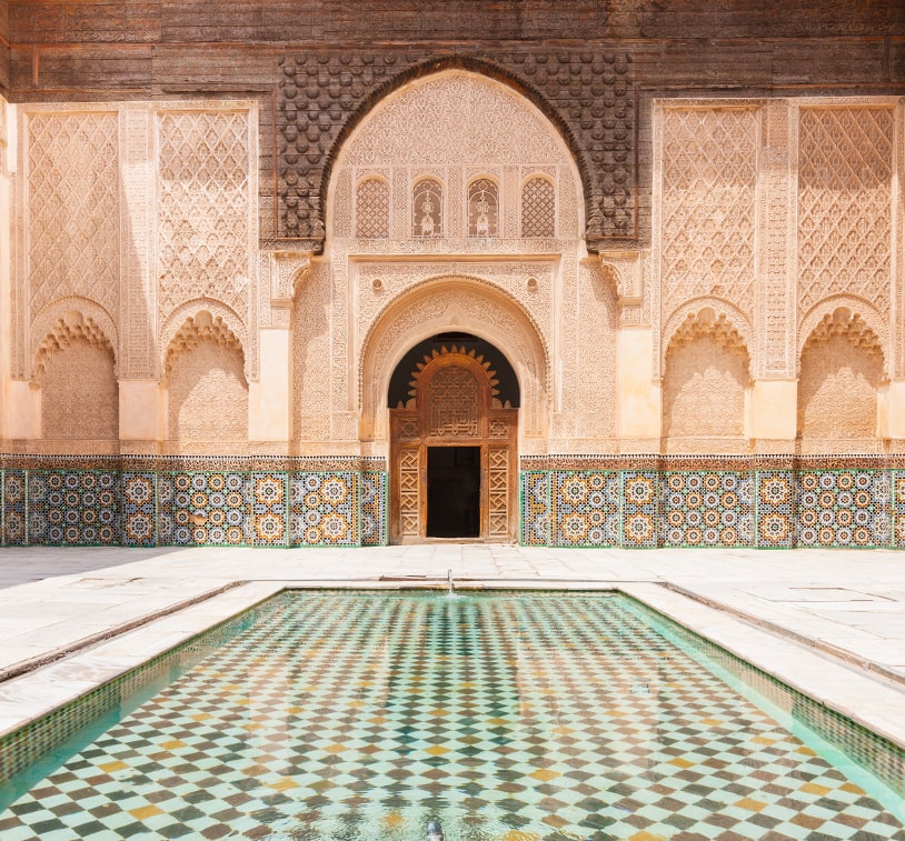 A picturesque scene of the royal palace courtyard in Marrakesh, Morocco, highlighting its stunning architecture and tranquil atmosphere.