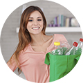 One young beautiful woman holding a reusable recylcing bag full of botles. More files of this model ans series on port. Vertical format.