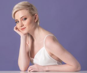 Elegant young woman posing with her stylish blonde short hair demonstrating the top hairstyles for short hair in 2018
