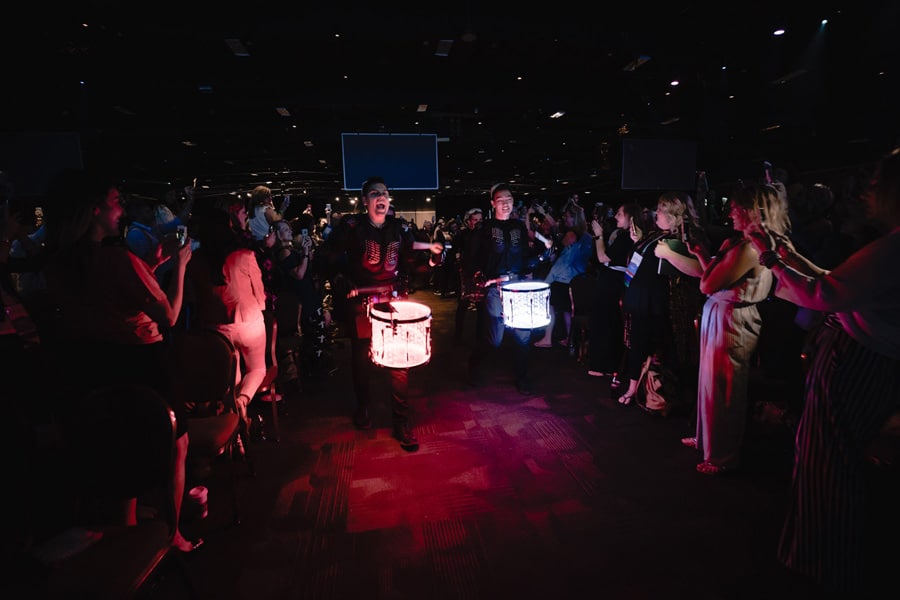 Two drummers playing on a lightup drum at night time during Las Vegas MONAT Reunion.