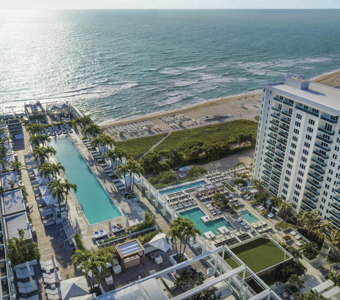 Aerial view of hotel in Miami located by the beach.