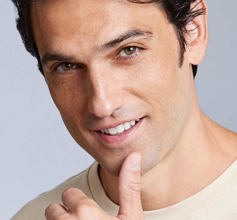 A closeup of a woman applying MONAT’s Silky & Soothing Hand Cream onto her hands. This image reveals the cream's white 
      texture.