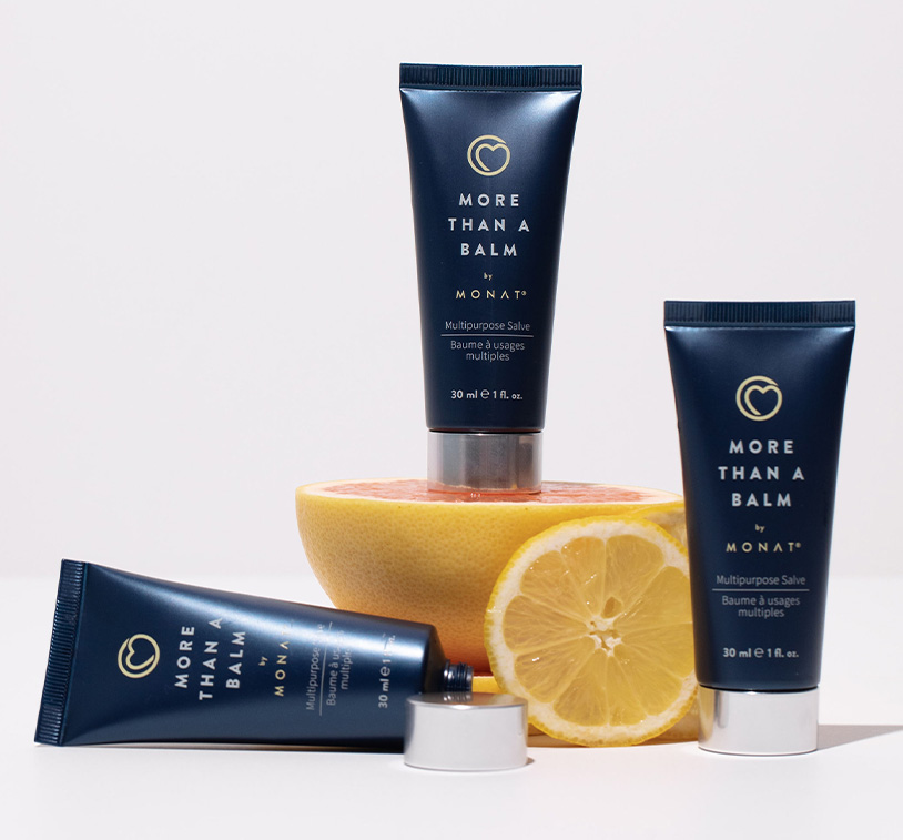 MONAT’s Silky & Soothing Hand Cream lays centered over a solid peach color background exhibiting its main ingredients such 
         as coconut & oils ornamenting the main product. 
