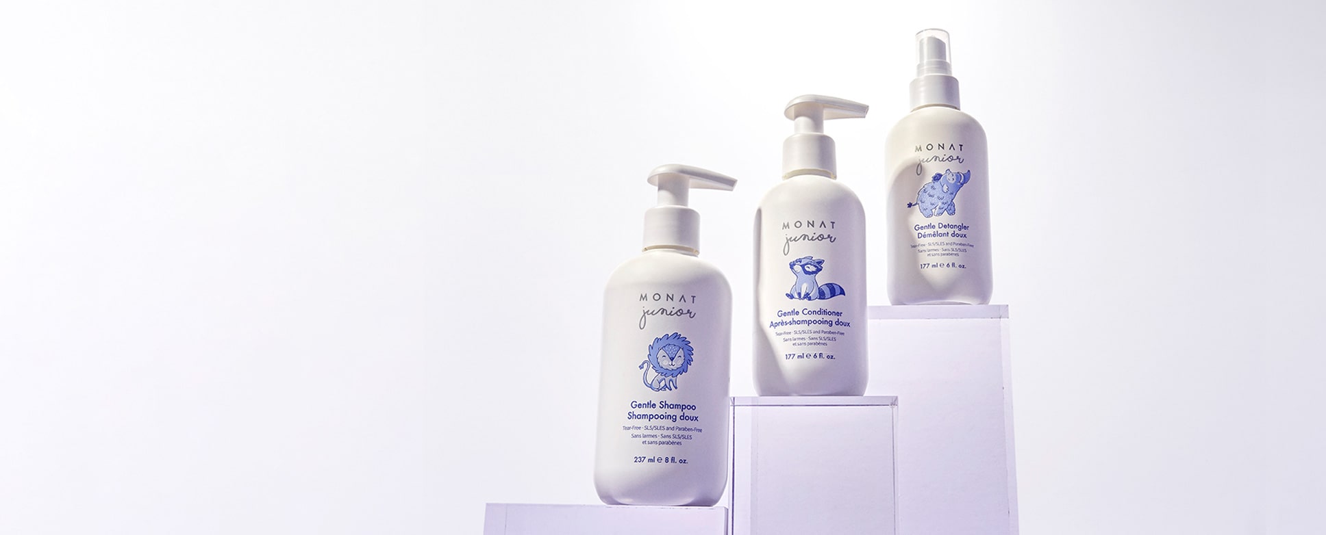  MONAT Junior products standing on clear stands.  
