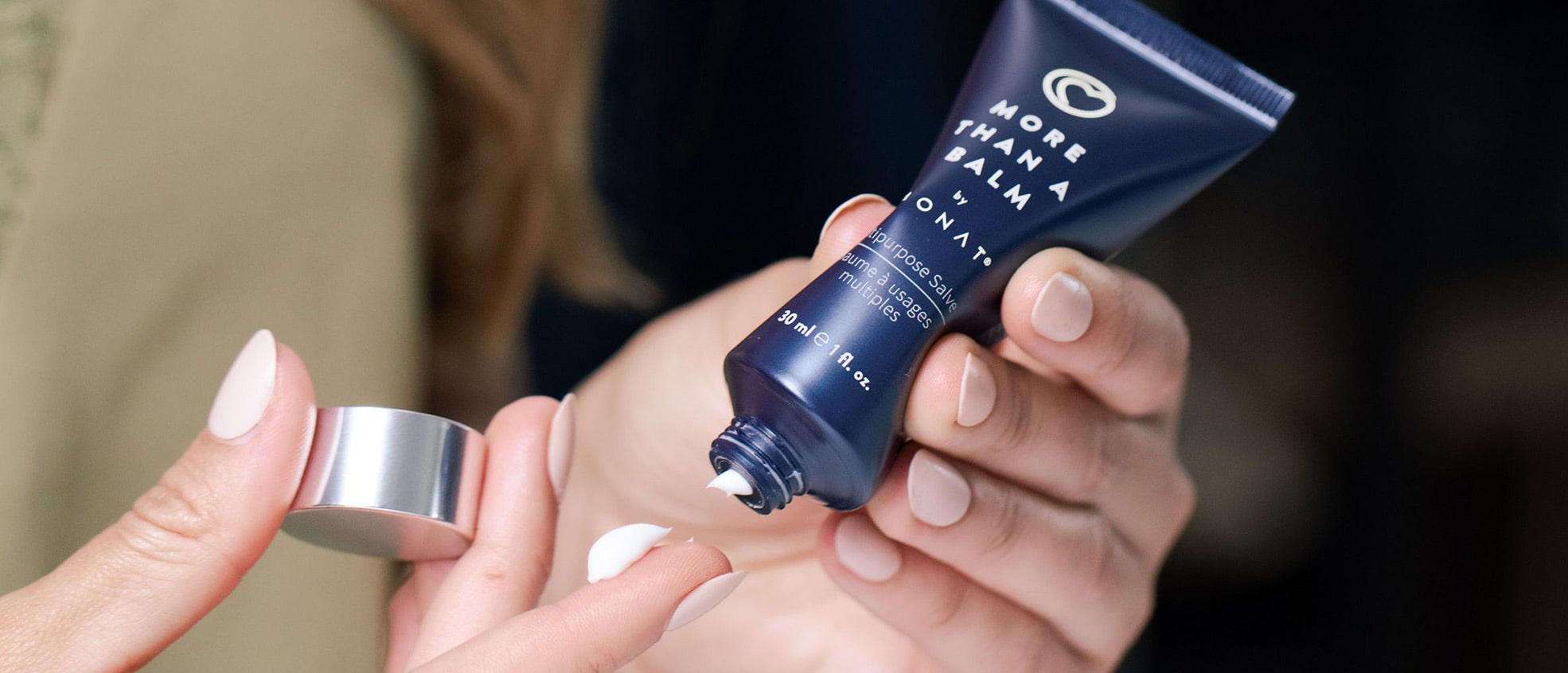 close up of hands applying More than a Balm by MONAT™