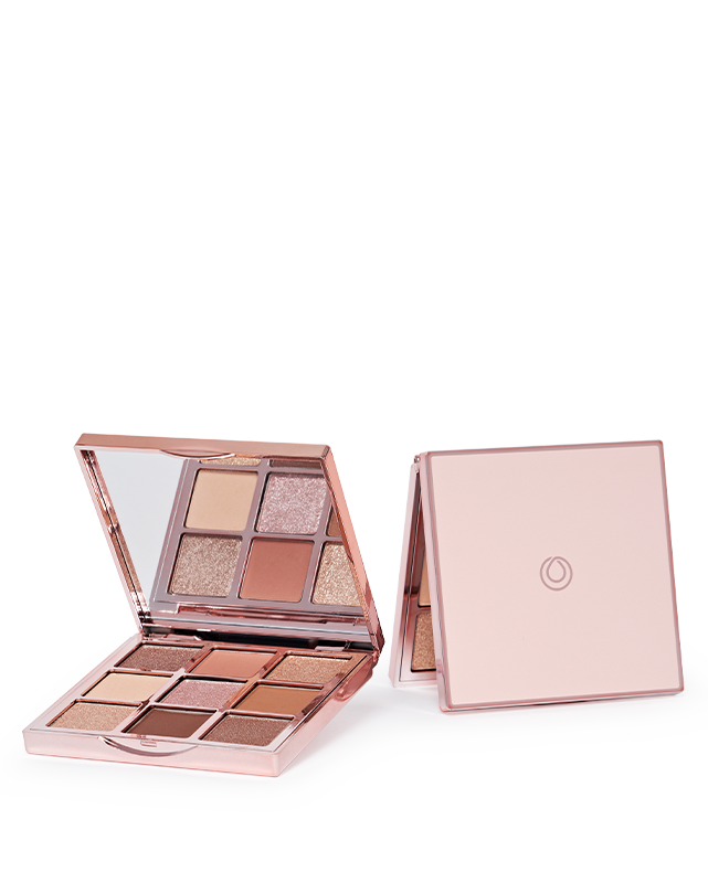 Image of the Glam Essentials Palette, featuring a collection of eyeshadows in neutral and radiant tones, shown with its packaging.