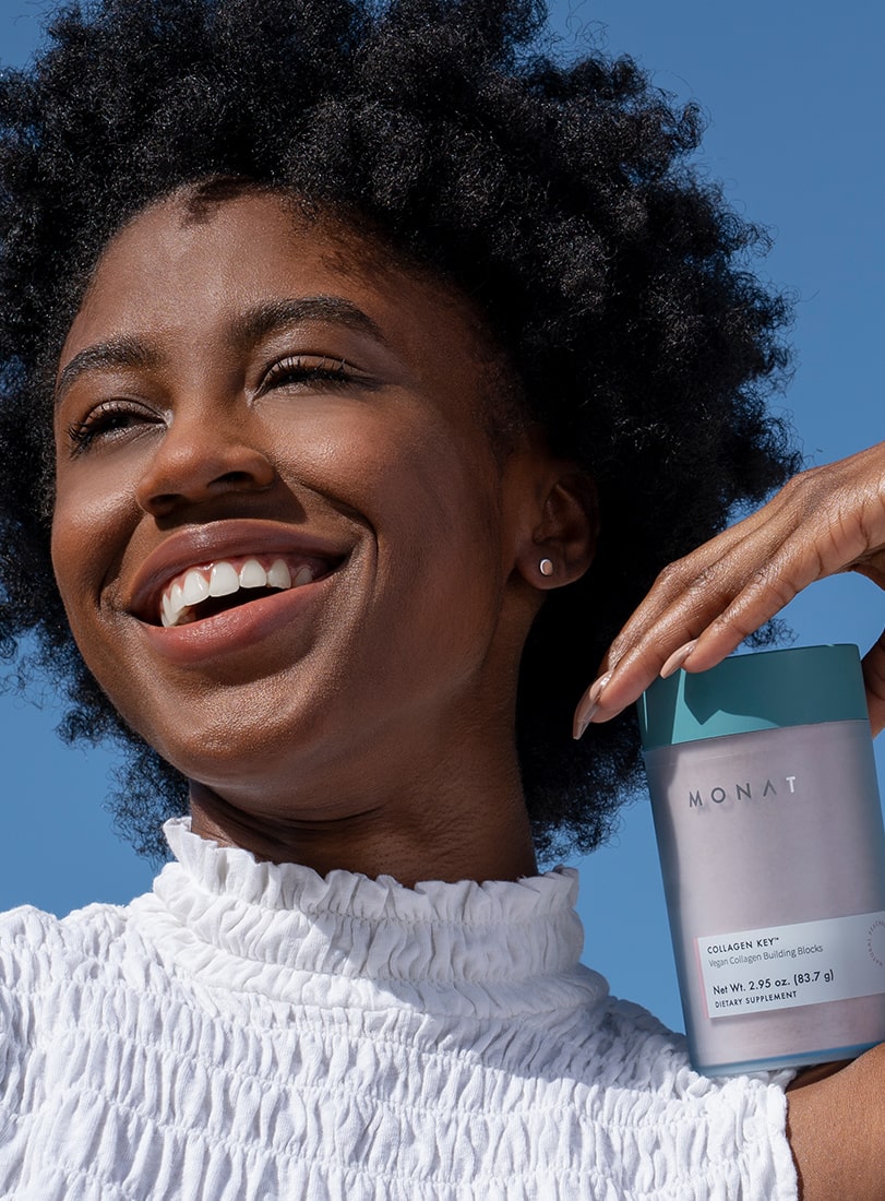 A woman stirring a drink of MONAT COLLAGEN KEY with a spoon