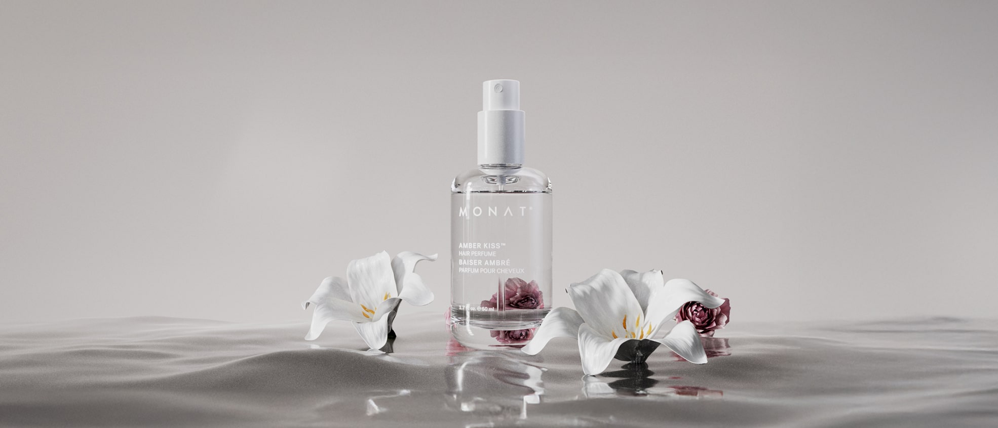 Amber Kiss Hair Perfume bottle with white and red flowers on a glossy surface