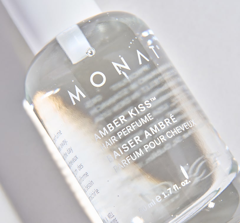 Close-up of Amber Kiss Hair Perfume bottle showing label details