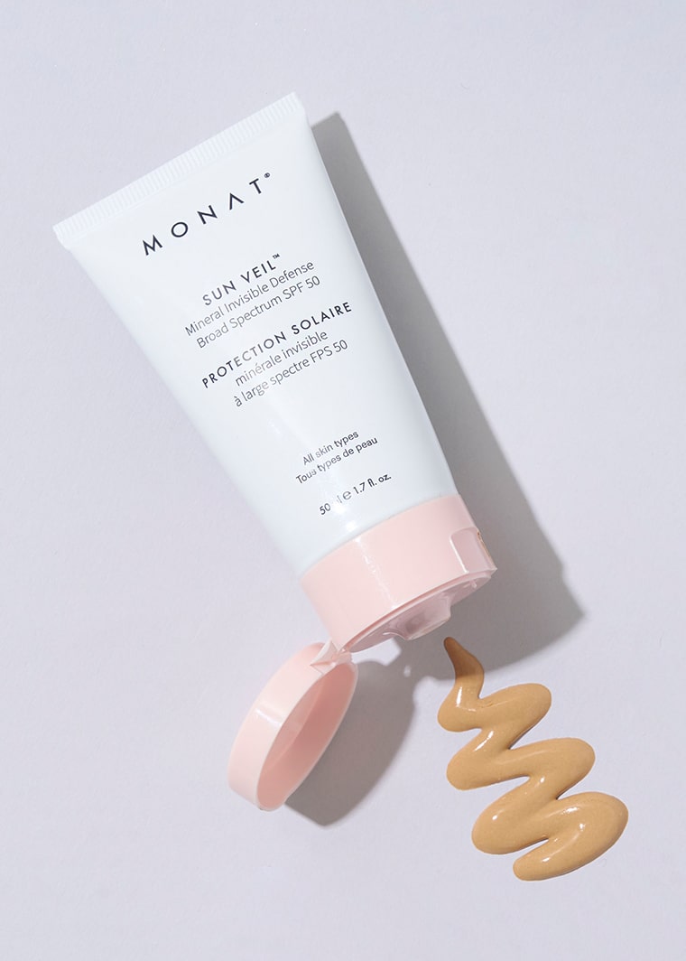 MONAT Sun Veil SPF 50 tube with pink cap open, showing swirled tinted sunscreen on a white background