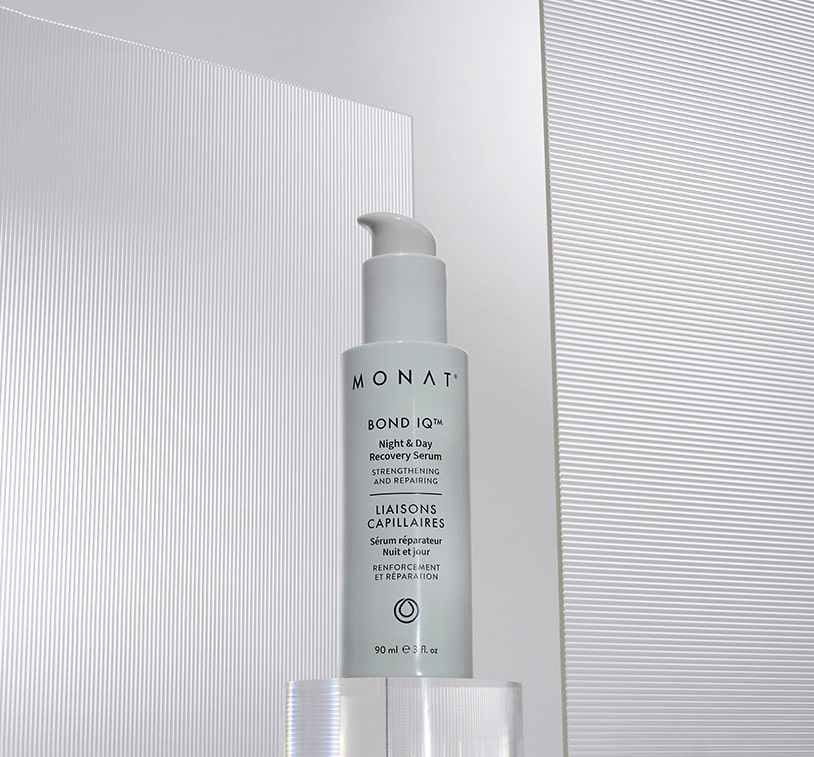 A single MONAT BOND IQ serum bottle positioned on a clear glass platform against a white background with subtle linear textures