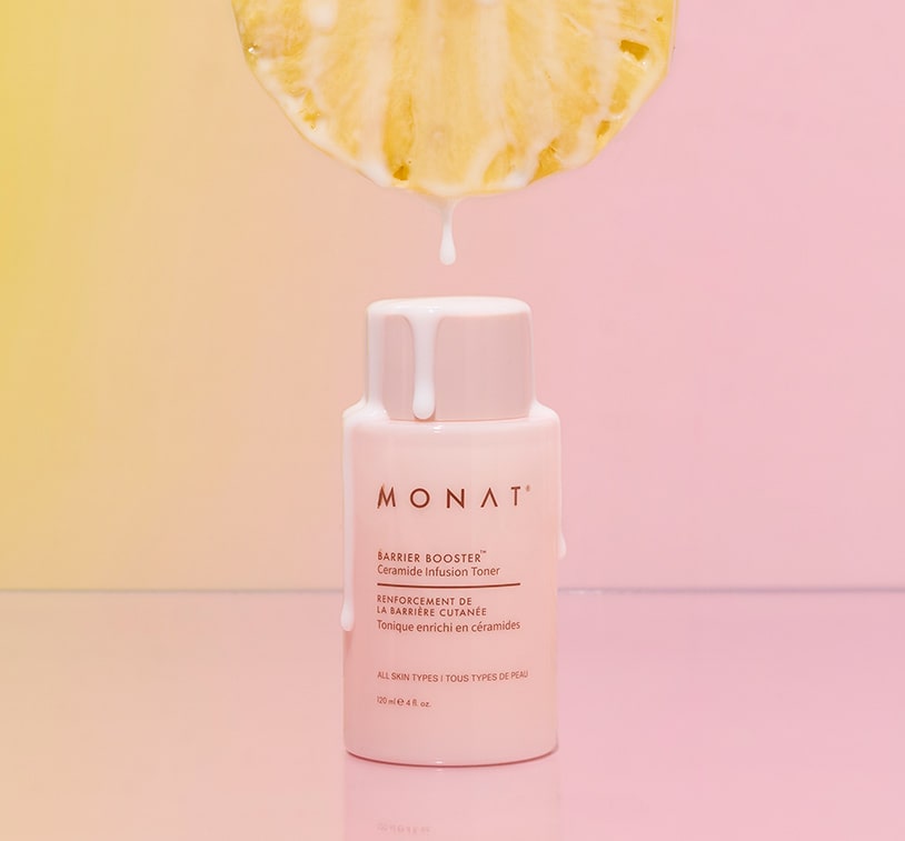 MONAT Barrier Booster™ Ceramide Infusion Toner bottle with creamy liquid dripping from a fresh pineapple slice above, set against a pink and yellow gradient background