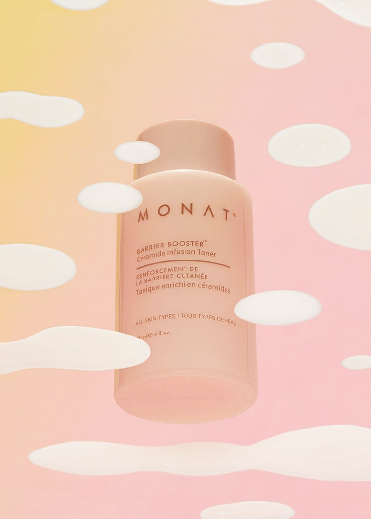 The toner bottle placed in front of a golden splash effect on a soft beige background