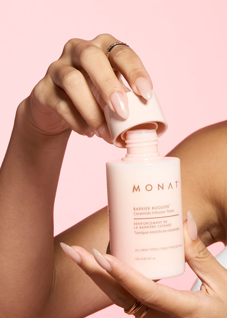  close up picture image of hands opening a bottle of Barrier Booster Ceramide Infusion Toner 