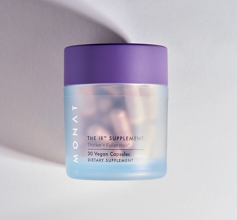 The MONAT supplement bottle photographed at an angle against a light background with soft shadowing