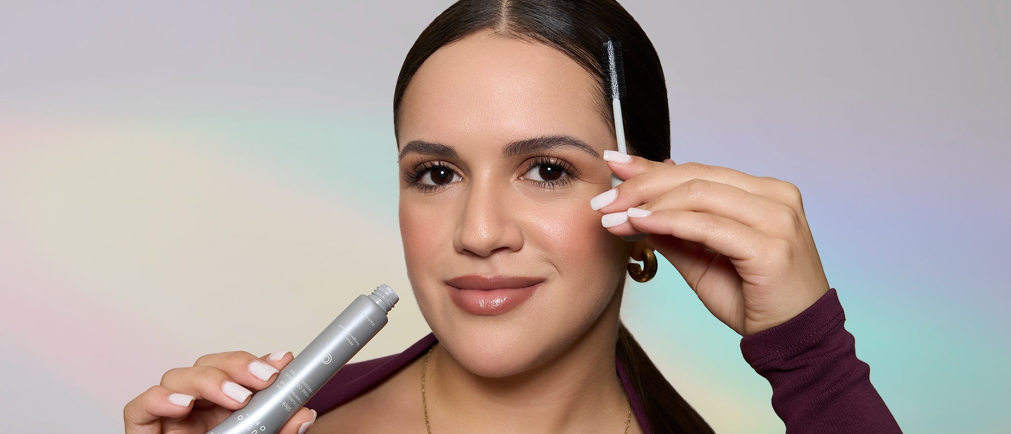 Model applying MONAT Studio One Slick Fix™ Styling Cream Taming Wand to smooth baby hairs and control frizz.