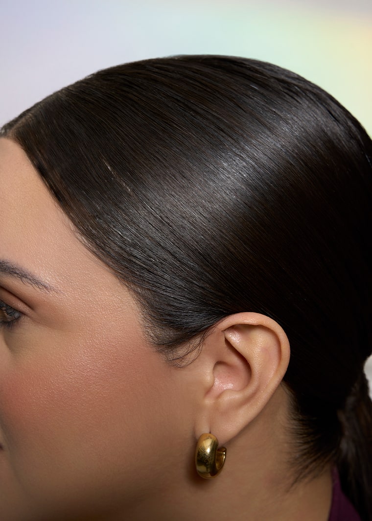 Close-up of smooth, polished hair after using Slick Fix™ Styling Cream Taming Wand.