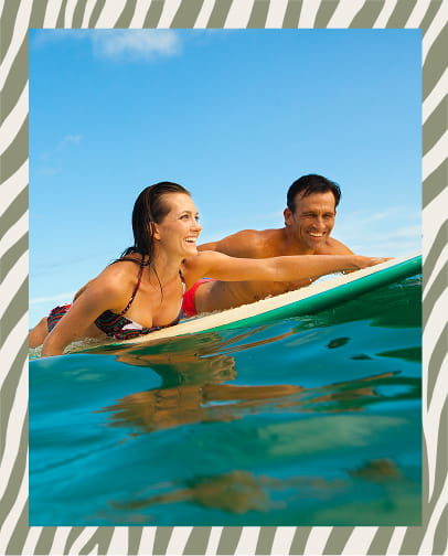 Resort pool area with palm trees and tropical landscaping