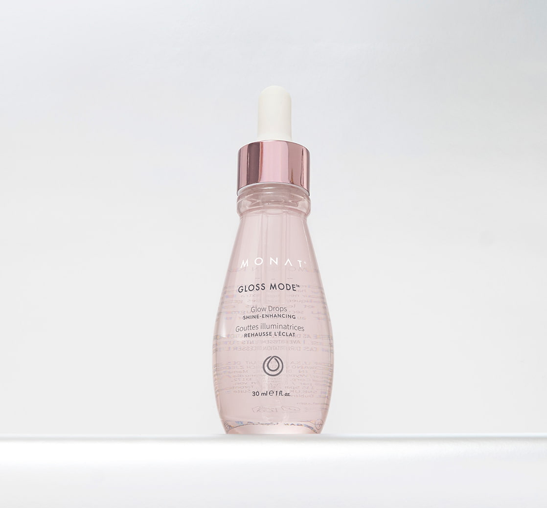 Gloss Mode Glow Drops in a clear, pink-tinted dropper bottle with a metallic pink cap, centered against a white background