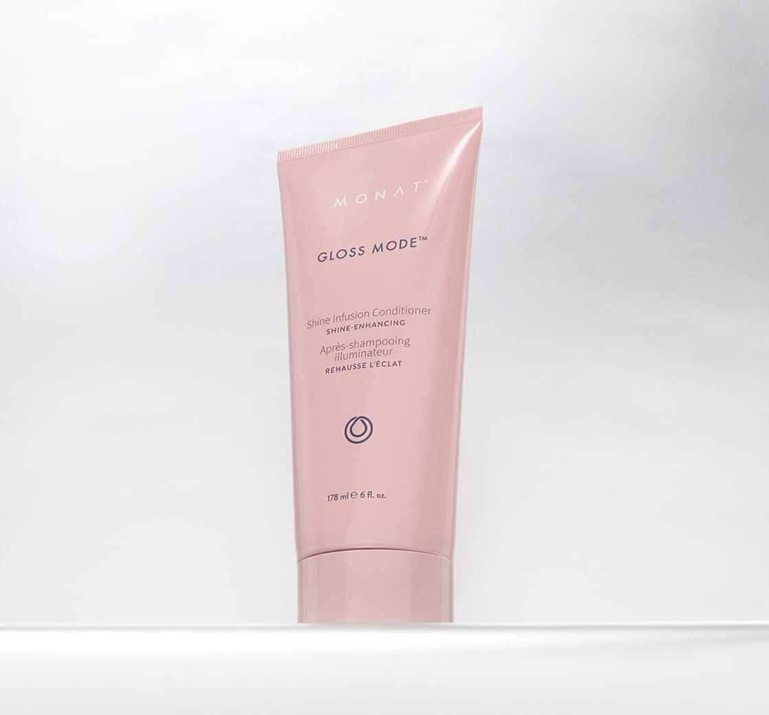 Pink MONAT Gloss Mode Shine Infusion Conditioner tube standing against a clean white background.