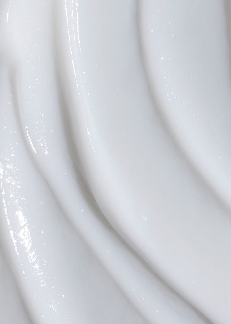 Close-up of glossy white creamy texture of MONAT GLOSS MODE Shine Infusion Conditioner